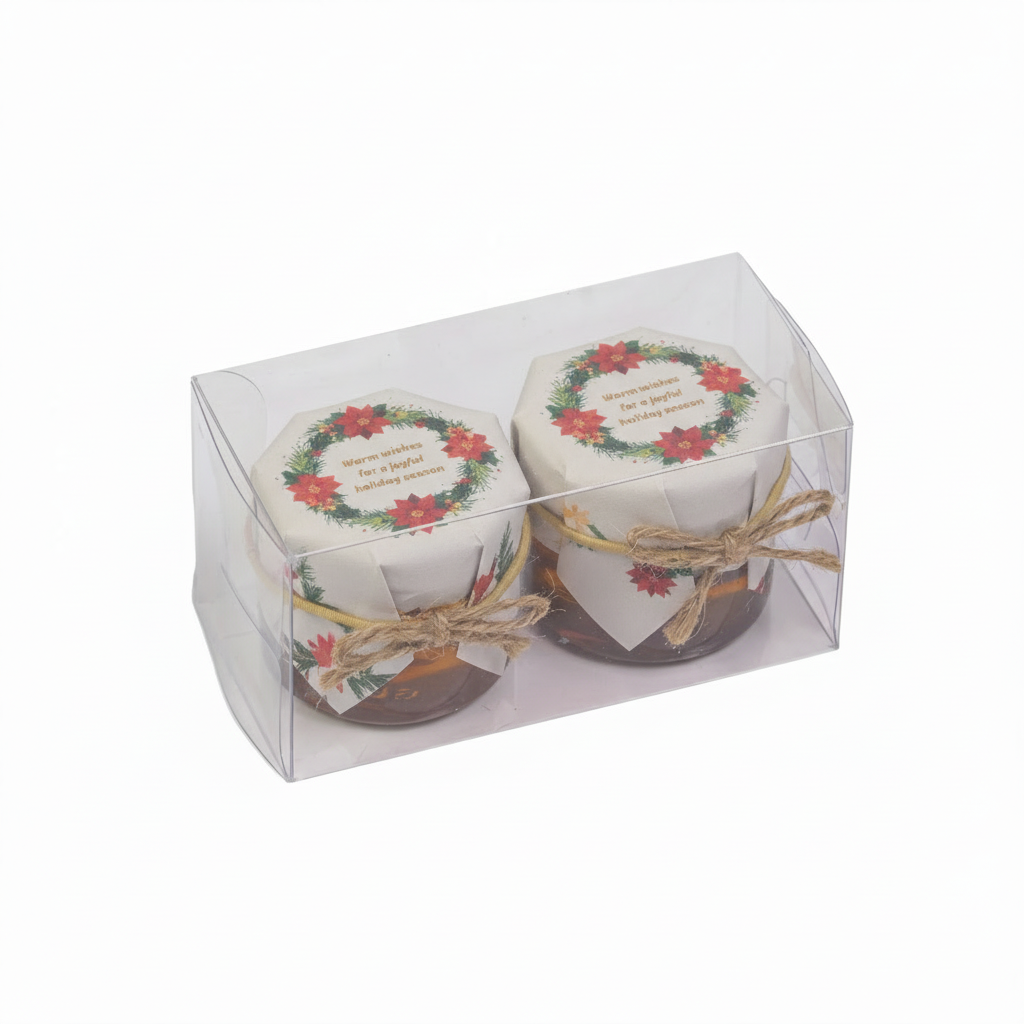 Two small jars with decorative labels in a clear packaging box on a white background