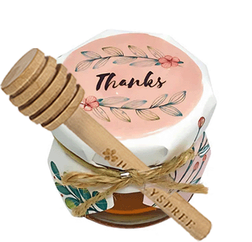 Small container with a wooden lid and decorative label on a white background