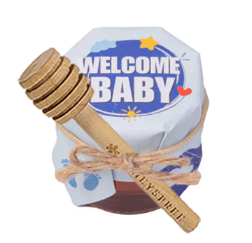 Baby shower gift set with 'Welcome Baby' sign and wooden spoon on a white background