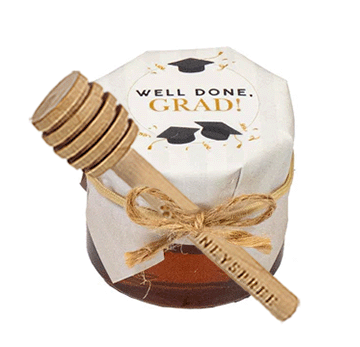 Honey jar with a wooden dipper labeled 'Well Done, Grad!' on a white background