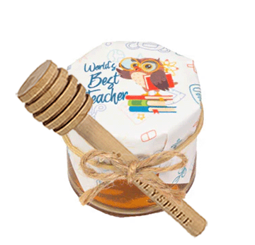 Honey jar with a wooden dipper labeled 'World's Best Teacher' on a white background