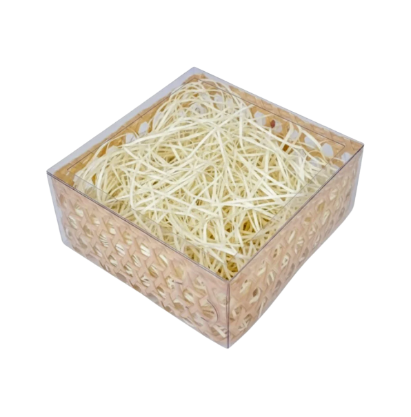 Transparent square plastic basket with woven-style sides, filled with thin light-colored shredded packing straw, shown on a transparent background.