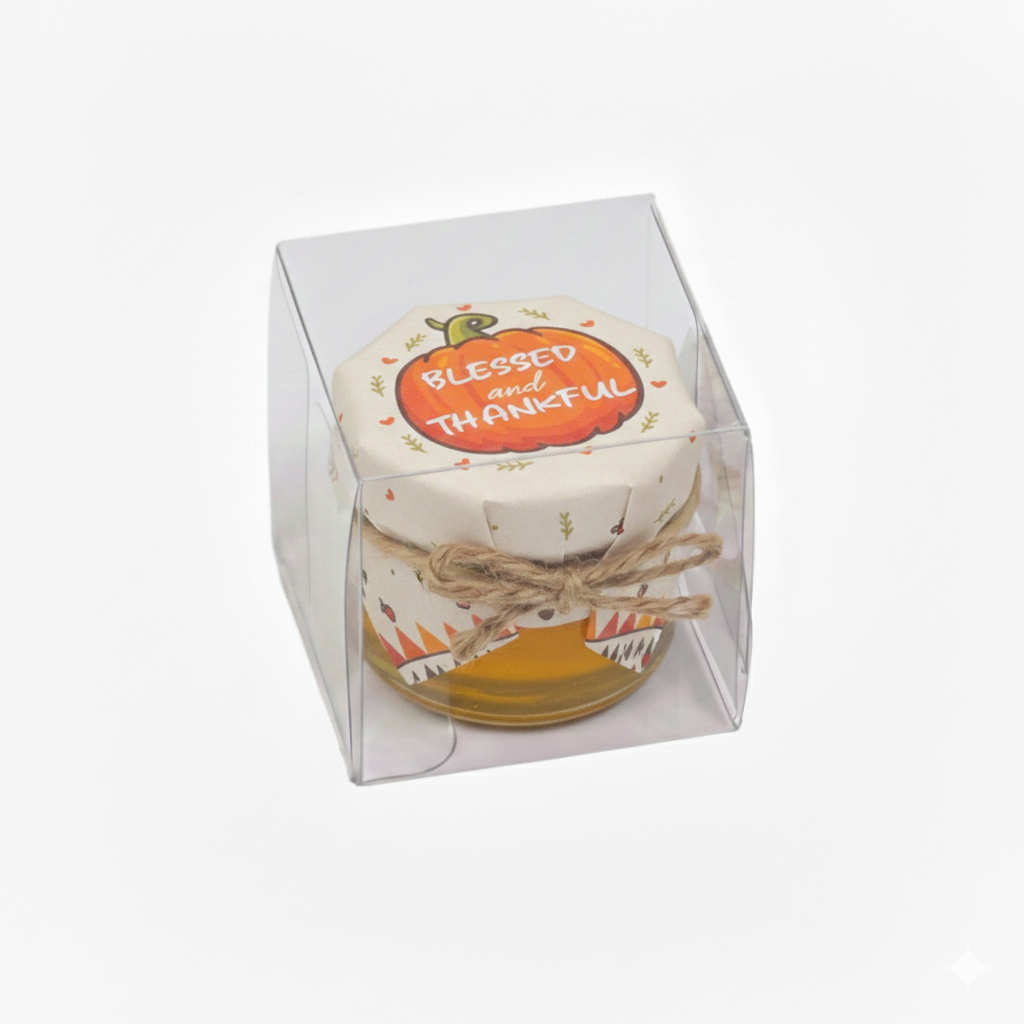 Decorative jar with pumpkin design and 'Blessed and Thankful' text in a clear box on a white background