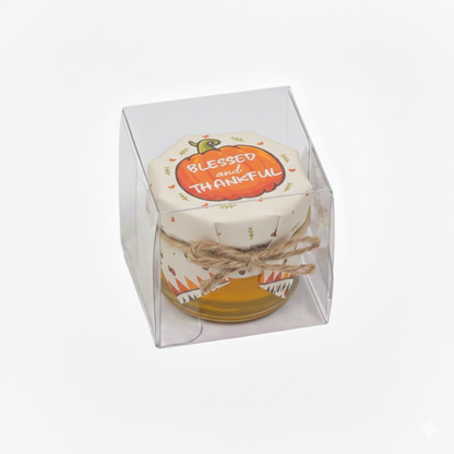 Decorative jar with pumpkin design and 'Blessed and Thankful' text in a clear box on a white background