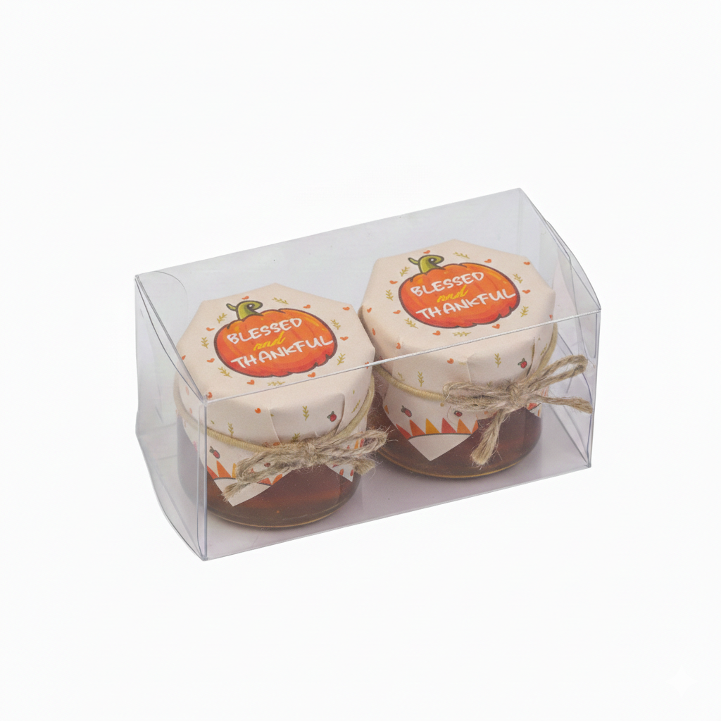 Two small jars with 'Blessed' and 'Thankful' labels in a clear packaging box on a white background.