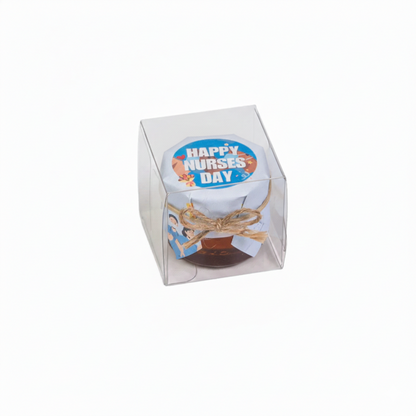 Honey jar in a box with 'Happy Nurses Day' decoration on a white background