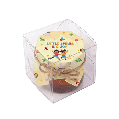 Small honey jar gift with Little Smiles, Big Joy packaging, presented in a transparent single clear box.
