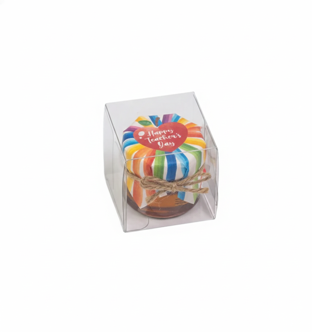 Colorful Honey jar in a clear box with 'Happy Teacher's Day' text on a white background