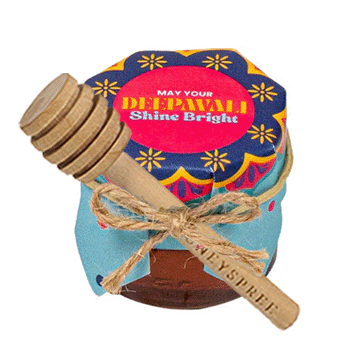 Festive “Happy Deepavali” gift jar and wooden spoon on a white background