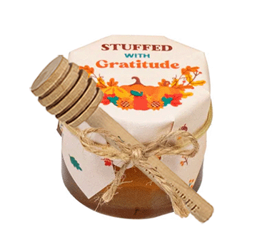 Small jar labeled 'Stuffed with Gratitude' on a white background