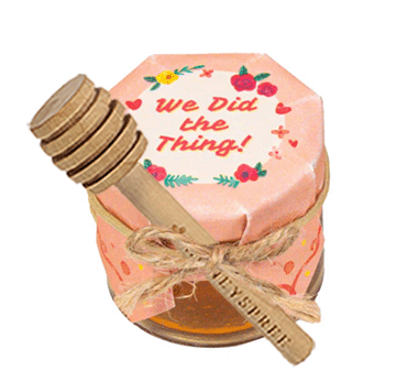 Small pink jar with wooden lid and decorative text on a white background