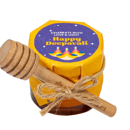 Jar of honey with a wooden dipper, featuring a 'Happy Deepavali' label on a white background.