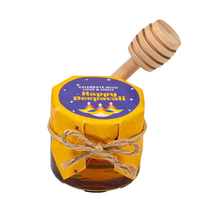 Jar of honey with a wooden dipper and 'Happy Deepavali' label on a white background