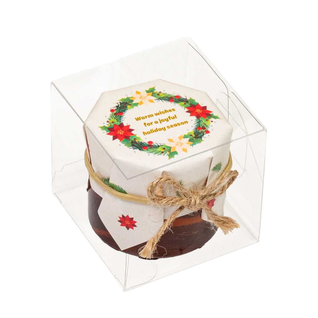 Small hexagonal holiday-themed container with a decorative lid in a clear box.