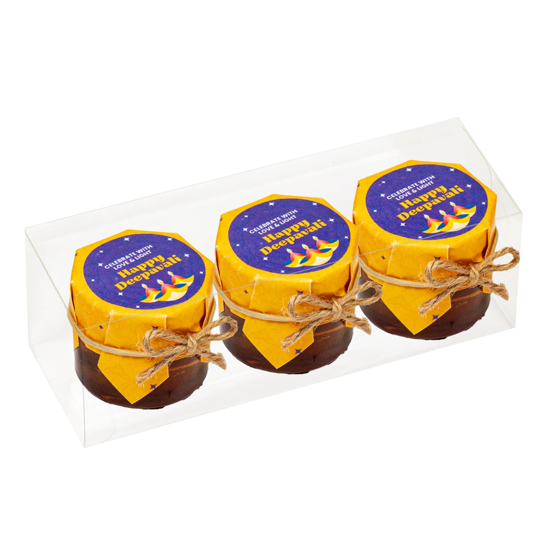 Three small jars with yellow lids and decorative labels on a white background